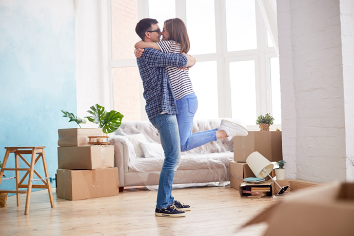 couple hugging after buying a house